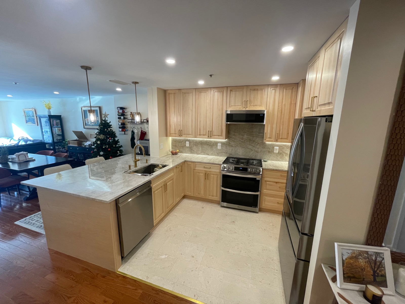 Open-plan kitchen remodel with island and quartzite countertops